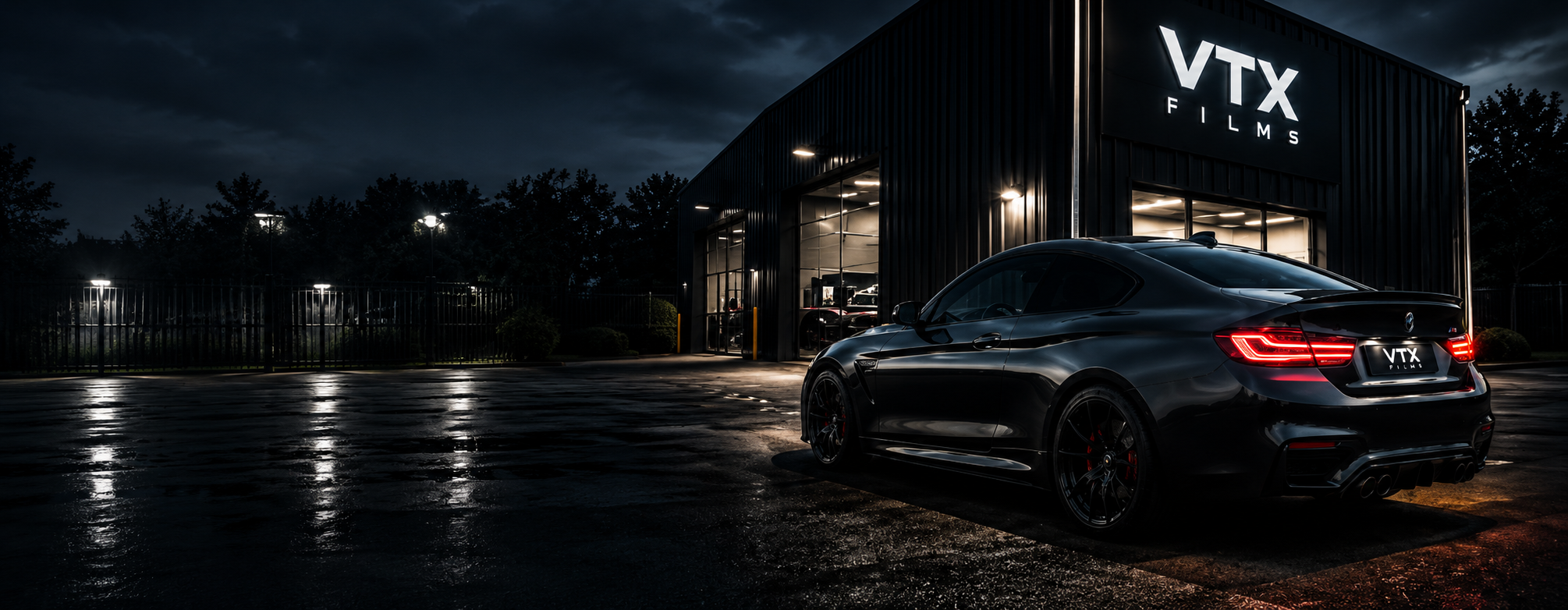 Black car parked in front of a building with 'VTX Films' signslider_item_JQaG7e